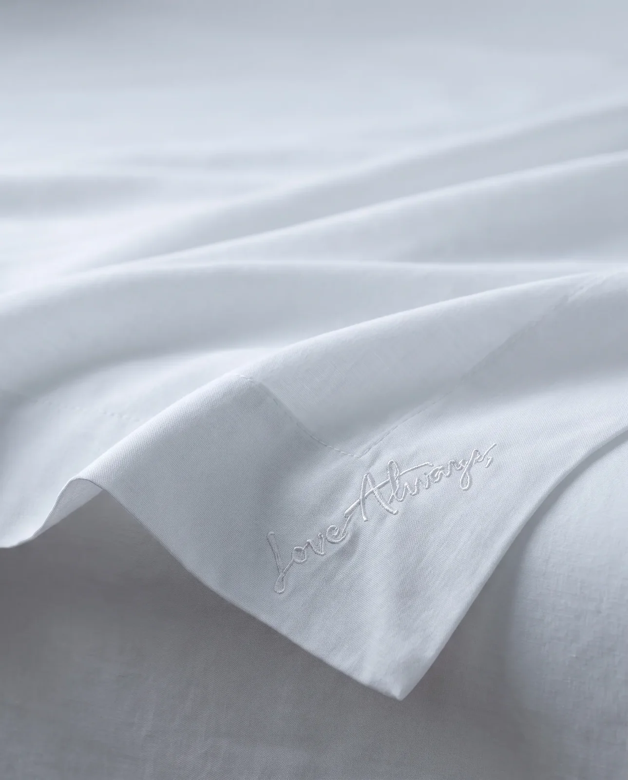 Custom embroidered monogram on organic cotton fabric